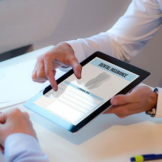 An insurance agent discussing dental insurance with a patient