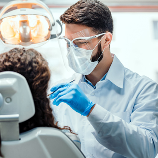 A dentist giving a woman a smile makeover