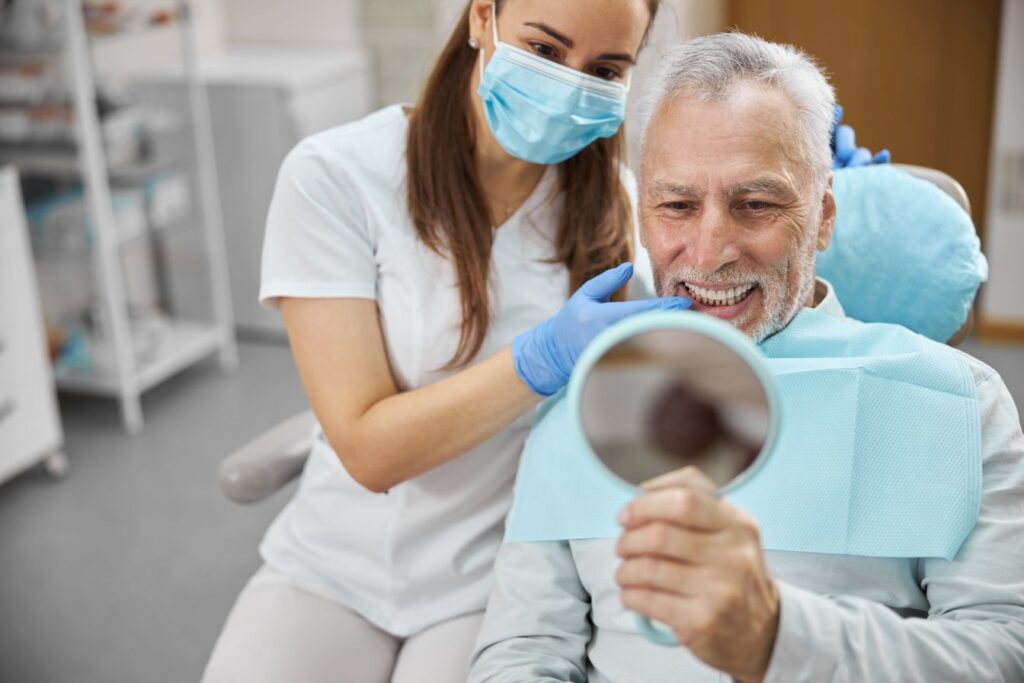 A man looking at his new dental implants